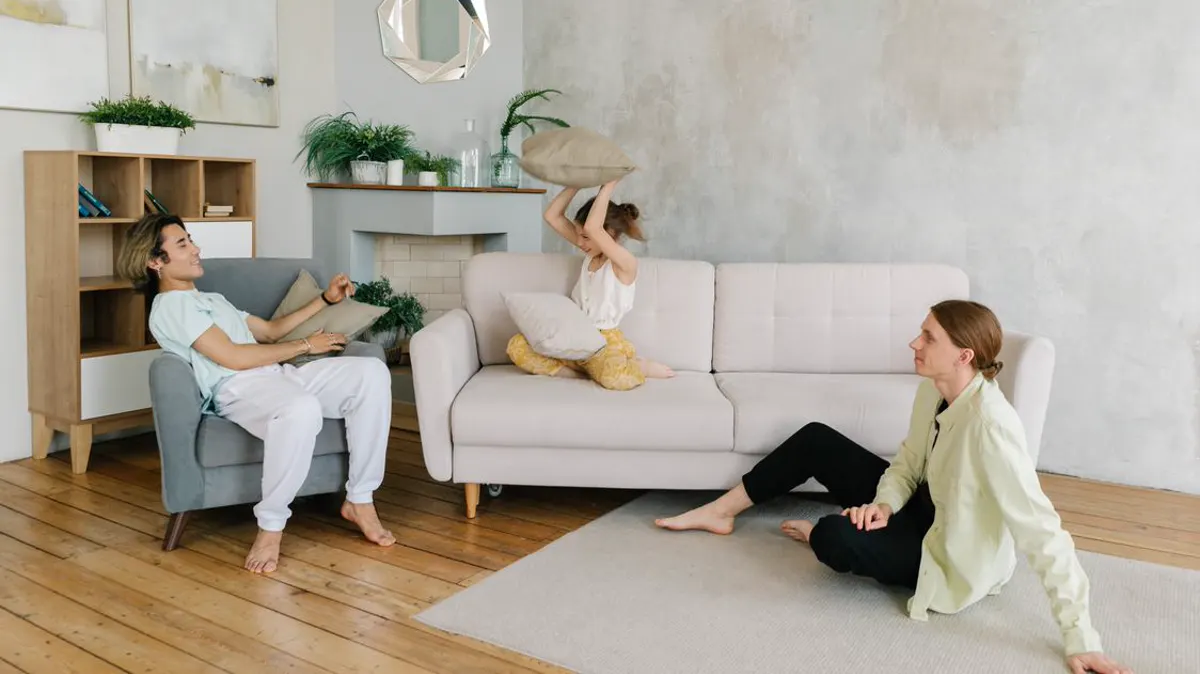 A family relaxing comfortably in a bright living room — the outcome HVAC customers are really buying when their call gets answered