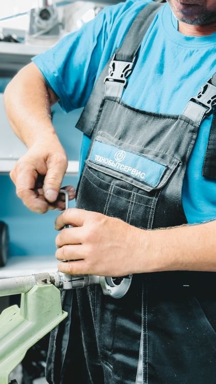 AI receptionist for plumbers — plumber repairing a burst pipe under a sink